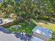 Expansive backyard featuring a stone fire pit, storage shed, mature shade trees and fenced pool area at 4009 S Renellie Dr, Tampa, FL 33611