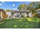 Backyard featuring a well-kept lawn, outdoor sitting area, and tidy exterior at 4009 S Renellie Dr, Tampa, FL 33611
