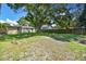 Expansive backyard with mature trees and a wooden fence surrounding the property at 4009 S Renellie Dr, Tampa, FL 33611