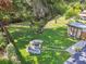 Expansive backyard featuring a stone fire pit, storage shed, and mature shade trees at 4009 S Renellie Dr, Tampa, FL 33611