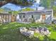 This backyard offers a stone fire pit, patio, and well-manicured lawn at 4009 S Renellie Dr, Tampa, FL 33611
