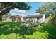 Well-maintained backyard with green lawn, fire pit area, shed, and charming exterior at 4009 S Renellie Dr, Tampa, FL 33611