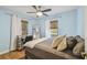 Bedroom featuring a large mirror, a ceiling fan, and a window providing natural light at 4009 S Renellie Dr, Tampa, FL 33611