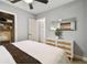 Bright bedroom featuring a ceiling fan, mirror, a closet with shelving, and a stylish dresser at 4009 S Renellie Dr, Tampa, FL 33611