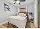 Tranquil bedroom featuring a comfortable bed, stylish decor, and a ceiling fan at 4009 S Renellie Dr, Tampa, FL 33611