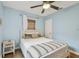 Well-lit bedroom with a ceiling fan, warm hardwood floors, and neutral decor at 4009 S Renellie Dr, Tampa, FL 33611
