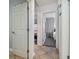 Hallway features tiled flooring, leading to bedrooms with neutral tones and natural light at 4009 S Renellie Dr, Tampa, FL 33611
