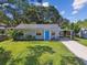 Charming home with a bright blue door and well-manicured front yard at 4009 S Renellie Dr, Tampa, FL 33611