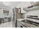 Bright kitchen with stainless steel refrigerator, electric range, and breakfast table near the window at 4009 S Renellie Dr, Tampa, FL 33611