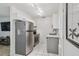 Compact kitchen features stainless steel appliances, white cabinets and tiled floors at 4009 S Renellie Dr, Tampa, FL 33611