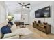 Bright living room with tile floors, neutral decor, sectional couch, ceiling fan, and ample natural light at 4009 S Renellie Dr, Tampa, FL 33611