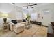 Bright living room with tile floors, neutral decor, sectional couch, ceiling fan, and ample natural light at 4009 S Renellie Dr, Tampa, FL 33611