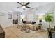 Bright living room with tile floors, neutral decor, sectional couch, ceiling fan, and ample natural light at 4009 S Renellie Dr, Tampa, FL 33611