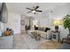 Bright living room with tile floors, neutral decor, sectional couch, ceiling fan, and ample natural light at 4009 S Renellie Dr, Tampa, FL 33611