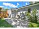 Outdoor patio with cozy seating, lush greenery, and a charming house exterior at 4009 S Renellie Dr, Tampa, FL 33611