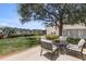 Serene backyard with patio seating, lush lawn, a large shade tree, and tranquil water views at 4214 Harbor House Dr, Tampa, FL 33615