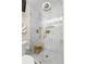 Modern bathroom with a frameless glass shower, marble tiling, and gold fixtures at 4214 Harbor House Dr, Tampa, FL 33615
