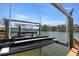 A well maintained boat lift and dock, set against a tranquil waterfront view at 4214 Harbor House Dr, Tampa, FL 33615