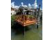 Exterior view of a waterfront dock with chairs, seating, and a ladder for easy access to the water at 4214 Harbor House Dr, Tampa, FL 33615