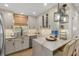 Modern kitchen with a marble island, updated appliances, and elegant lighting at 4214 Harbor House Dr, Tampa, FL 33615