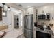 Modern kitchen with stainless steel appliances, stylish cabinetry, and a view to the laundry room at 4214 Harbor House Dr, Tampa, FL 33615