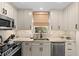 Contemporary kitchen featuring sleek cabinets, stainless steel appliances, and marble countertops at 4214 Harbor House Dr, Tampa, FL 33615