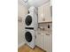 Convenient laundry room with stacked washer and dryer, and modern cabinetry at 4214 Harbor House Dr, Tampa, FL 33615