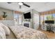 Comfortable main bedroom features a ceiling fan, built-in fireplace, and workspace at 4214 Harbor House Dr, Tampa, FL 33615