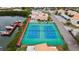 Aerial view of tennis and basketball courts adjacent to a waterway with docks at 4214 Harbor House Dr, Tampa, FL 33615