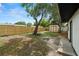 Spacious backyard highlighting a new fence, mature trees, and a convenient storage shed, perfect for outdoor enjoyment at 4414 W Oklahoma Ave, Tampa, FL 33616