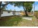 Private backyard showcasing a new fence, mature trees, and easy access to the home at 4414 W Oklahoma Ave, Tampa, FL 33616