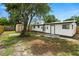 Spacious backyard featuring mature trees, a storage shed, and a new fence, offering a private outdoor retreat at 4414 W Oklahoma Ave, Tampa, FL 33616