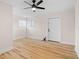 Bright bedroom featuring hardwood floors, a ceiling fan, and two windows at 4414 W Oklahoma Ave, Tampa, FL 33616