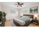 Comfortable bedroom featuring warm lighting, a ceiling fan, and hardwood floors at 4414 W Oklahoma Ave, Tampa, FL 33616