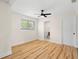 Well-lit bedroom featuring hardwood floors, a ceiling fan, and an en-suite bathroom at 4414 W Oklahoma Ave, Tampa, FL 33616