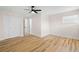 Spacious bedroom with a ceiling fan, closet, and wood-look flooring at 4414 W Oklahoma Ave, Tampa, FL 33616