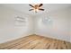 Cozy bedroom with neutral paint, wood-look flooring, and natural light from two windows at 4414 W Oklahoma Ave, Tampa, FL 33616