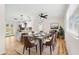 Bright dining room with modern decor, stylish lighting, and an open view of the kitchen at 4414 W Oklahoma Ave, Tampa, FL 33616