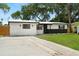 Attractive home with a well-maintained lawn, a paved driveway, and stylish exterior details, offering great curb appeal at 4414 W Oklahoma Ave, Tampa, FL 33616