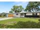 Inviting home with neat landscaping, a paved driveway, and attractive curb appeal in a quiet neighborhood setting at 4414 W Oklahoma Ave, Tampa, FL 33616