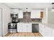 Beautiful kitchen with stainless steel appliances, white cabinets, and stone countertops at 4414 W Oklahoma Ave, Tampa, FL 33616