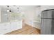 Bright kitchen features white cabinetry, stainless steel appliances, and stylish light fixtures at 4414 W Oklahoma Ave, Tampa, FL 33616