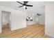 Open concept living room boasting hardwood floors and a view into the modern kitchen at 4414 W Oklahoma Ave, Tampa, FL 33616