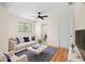 Cozy living room with hardwood floors, ceiling fan, and a neutral color palette at 4414 W Oklahoma Ave, Tampa, FL 33616