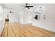 Spacious living room with hardwood floors and an open concept view of the modern kitchen at 4414 W Oklahoma Ave, Tampa, FL 33616
