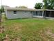 Spacious backyard featuring a grass area and view of the house and enclosed patio at 4417 Kohler St, New Port Richey, FL 34652