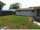 Spacious backyard featuring a grass area and view of the house and enclosed patio at 4417 Kohler St, New Port Richey, FL 34652