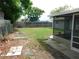 Spacious backyard featuring a grass area and partial view of the enclosed patio at 4417 Kohler St, New Port Richey, FL 34652