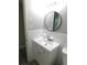 Bathroom featuring a new vanity and a round mirror at 4417 Kohler St, New Port Richey, FL 34652