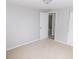 Neutral bedroom features carpet and walls with a door leading to another room at 4417 Kohler St, New Port Richey, FL 34652